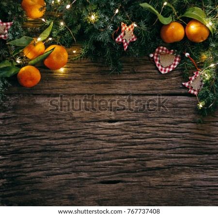 Christmas wooden background with fir tree, oranges and decoration