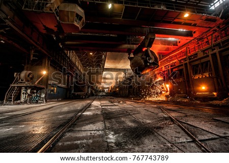 Pouring of liquid metal in open-hearth furnace Royalty-Free Stock Photo #767743789