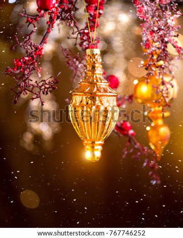 Christmas and New Year Golden Decoration. Abstract Blurred Bokeh Holiday Background with beautiful baubles and Blinking Garland. Christmas Tree Lights Twinkling. Xmas backdrop art design. Vertical