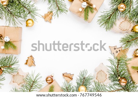 Christmas frame, pattern made in gold colors and craft boxes on white background with empty copy space for text. Holiday and celebration concept. Top view. Flat lay