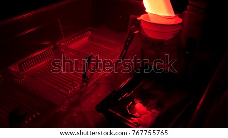 Retro print photos in the darkroom. Darkroom to develop film and create photos using different chemicals. Drying photos on rope. The manual process printingof old photos