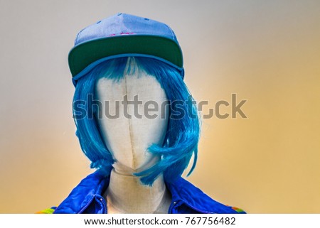 manga style teenage dummy with blue hair and cap
