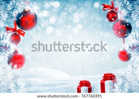Christmas background with red ornaments, gift boxes and falling snow 