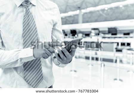 isolated business man hold the smartphone on shopping mall background with green color