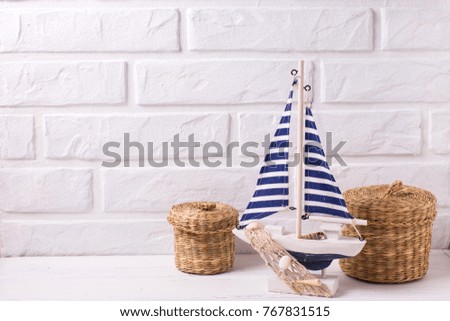 Decorative  wooden toy boat on white wooden background.  Place for text.