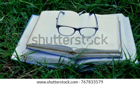 glasses on big book,Education themes