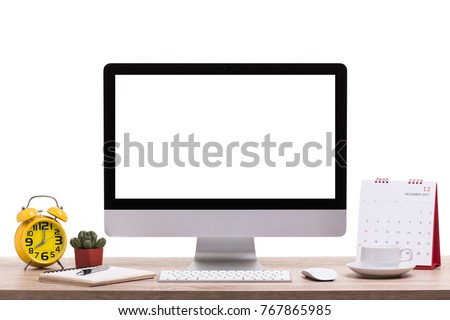 Modern desktop computer, Coffee cup, alarm clock, notebook and calendar on wooden table. Studio shot isolated on white background. Blank screen for graphics display montage.