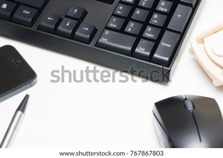 Computer keyboard and mouse, pen, wooden car, phone isolated on white background