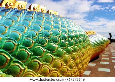 Rainbow colors of Body Molding with Praya Nark showing in Thai Temple Praya Nark or Naga is fabulous serpent or serpent dragon the big snake in Thai story on Blue sky Background