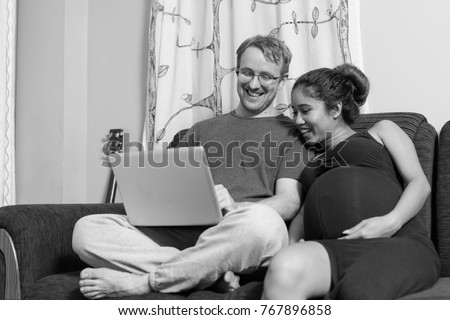 Portrait of multi-ethnic couple married and in love in the living room