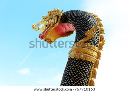 Black and Golden colors of Beautiful Molding of Praya Nark showing in Thai Temple Praya Nark or Naga is fabulous serpent or serpent dragon the big snake in Thai story on blue sky background from Thail
