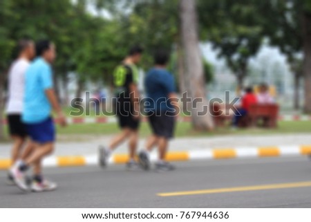 Blurred Photo of Group of people jogging exercise on street park outdoor