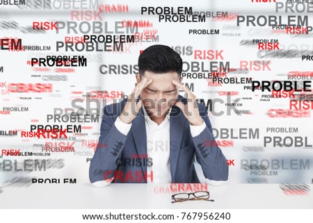 Stressed out Asian businessman with a strong headache. He is sitting at a table. Word problem in the background. 3d rendering mock up double exposure