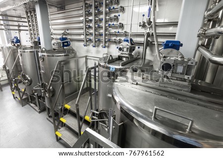 Steel tanks for mixing liquid. Food industry. Royalty-Free Stock Photo #767961562