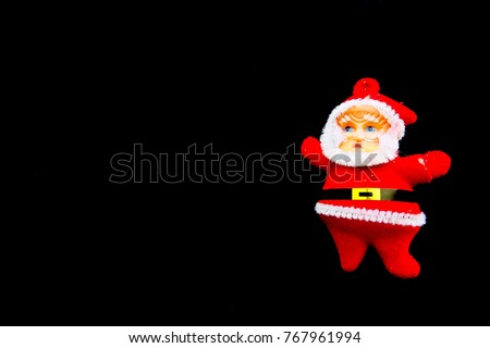Santa Claus doll on black background.