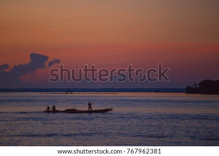 The silhouette of a fishing boat in Thailand in the morning.