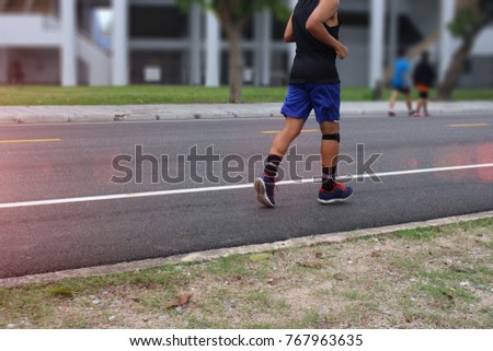 Blurred Photo of men jog exercise on street park outdoor 