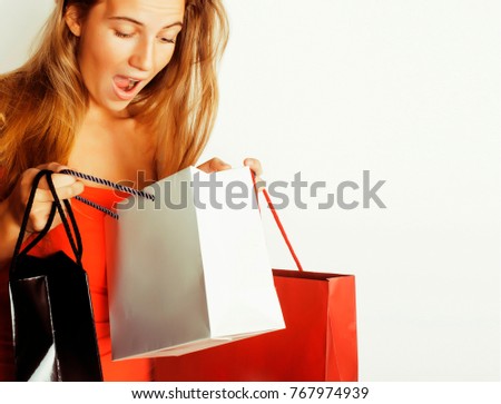 young pretty blond woman with bags on Christmas sale in red dress isolated white