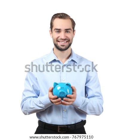 Handsome businessman with piggy bank on white background