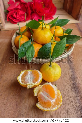 Tangerines,mandarin oranges and peony flowers are symbolic to chinese new year / Festive Fruits and Decors / Tangerine and mandarin signifies abundance,wealth and prosperity