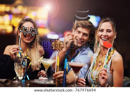 Picture showing group of friends enjoying drink in bar