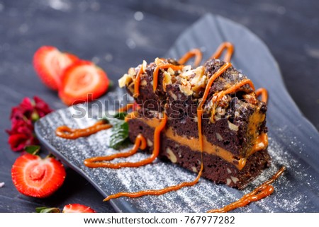 Caramel chocolate cake with fresh fruits. Restaurant menu. Royalty-Free Stock Photo #767977282