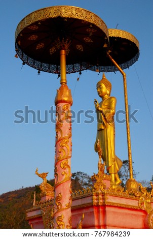 Golden Buddha statue with Buddha umbrella Thailand - Beautiful buddhist sculpture and pray for bless photography from chiang rai thailand