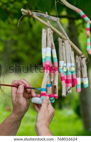 A person making crafts with driftwood