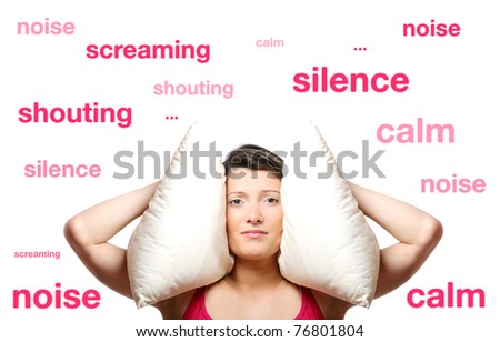 A portrait of a beautiful young woman covering her ears with a pillow over white background