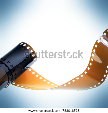 Twisted film strip on white and blue background.