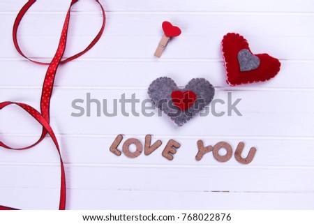 Blank instant photos and red heart hanging. On wooden background