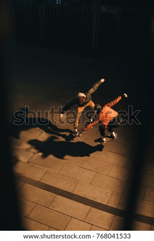 high angle view of skateboarders doing same trick together