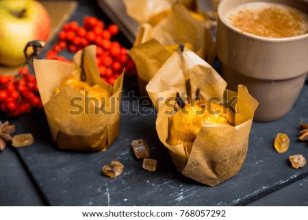 Muffins with pumpkin and apples on the rustic background with autumn decorations. Selective focus.