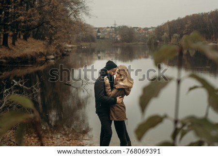 Loving couple at the lake, a love story, feeling beautiful, sunny and smiling, love. Soft focus