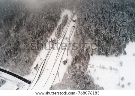 Aerial drone view on ski jump in Szczyrk during cold foggy winter weather