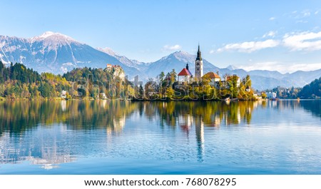 Lake Bled Slovenia. Beautiful mountain lake with small Pilgrimage Church. Most famous Slovenian lake and island Bled with Pilgrimage Church of the Assumption of Maria and Bled Castle in background. Royalty-Free Stock Photo #768078295