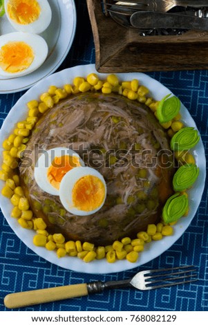 Traditional chicken jelly with sweet corn, green peas, leek and boiled egg. 