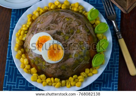 Traditional chicken jelly with sweet corn, green peas, leek and boiled egg. 