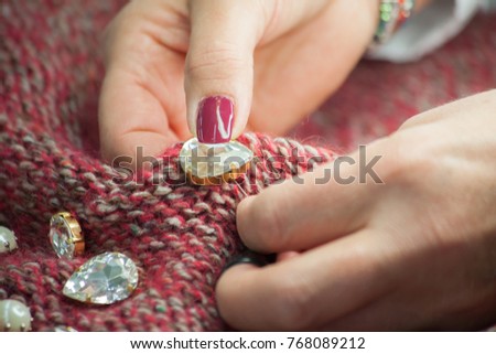 tailoring, sewing buttons on wool fabric