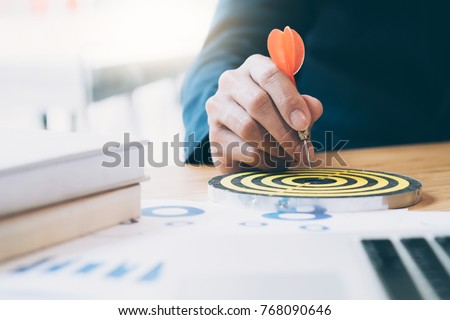 Businessman holding red dart push on target. Business strategy planning success target goals. Business development concept Royalty-Free Stock Photo #768090646