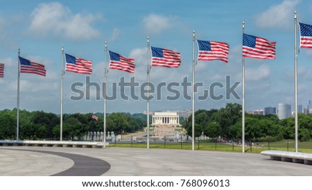 Washington DC skyline including Lincoln Memorial and American flags.