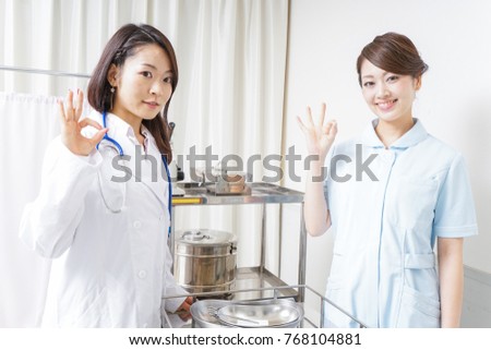 Doctor and nurse giving ok sign