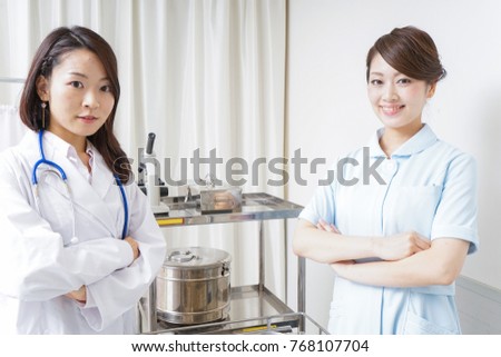 Doctor and nurse crossing arms