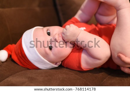 Portrait of newborn baby for New Year's holidays. Baby with Santa hat