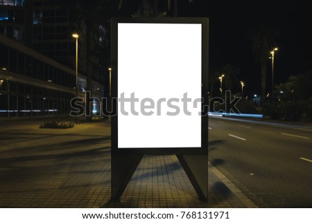 Blank white advertisement lightbox by the road at night. Mock-up design concept.