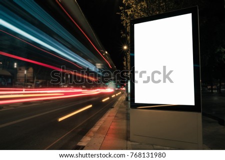 Blank white advertisement lightbox at night. Mock-up design concept. Car lights.