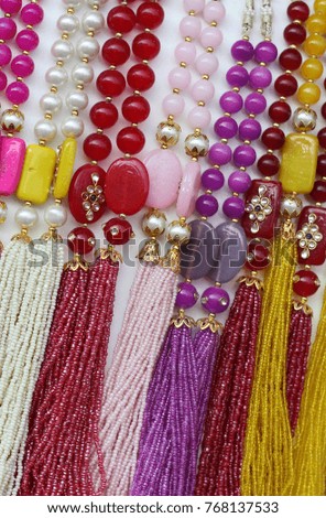 
Indian necklace with beads and stones in display in front of shop for sale