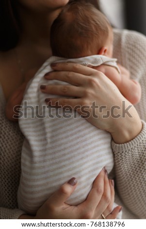 mother holds her baby