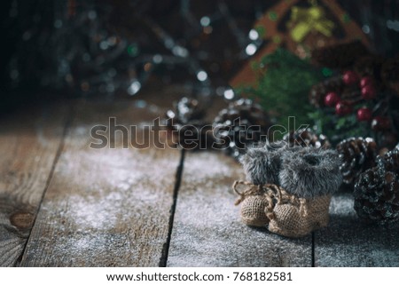Christmas background with decorations on a Christmas tree handmade, winter boots. Soft focus. Festive still life