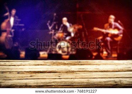 desk for your decoration and blurred background of music stage. 